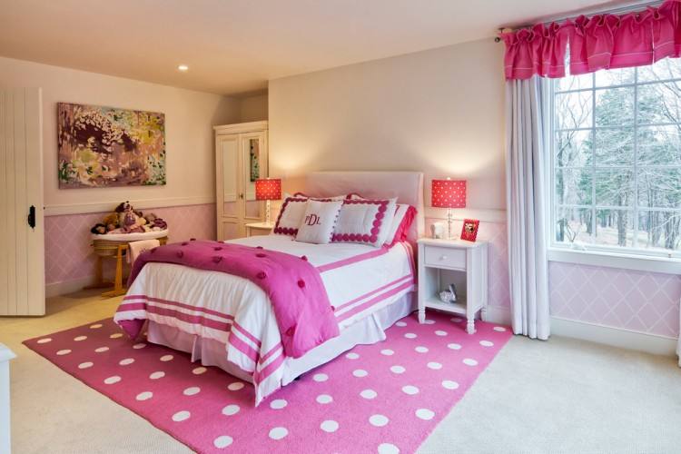 Decorate with a rug and a piece of art that feature matching colors to create a cohesive look in your red bedroom