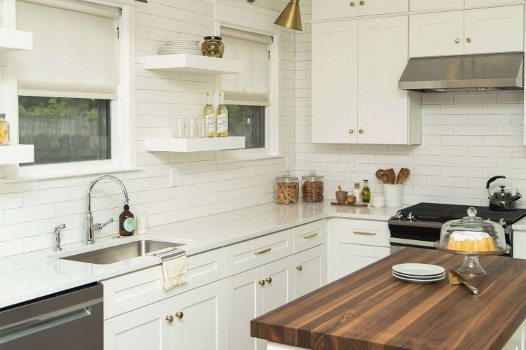 Kitchen image of white cabinets and white backsplash and stainless appliances