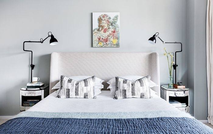 Contemporary bedroom with red walls and bed along with smooth white  flooring and pendant lamps