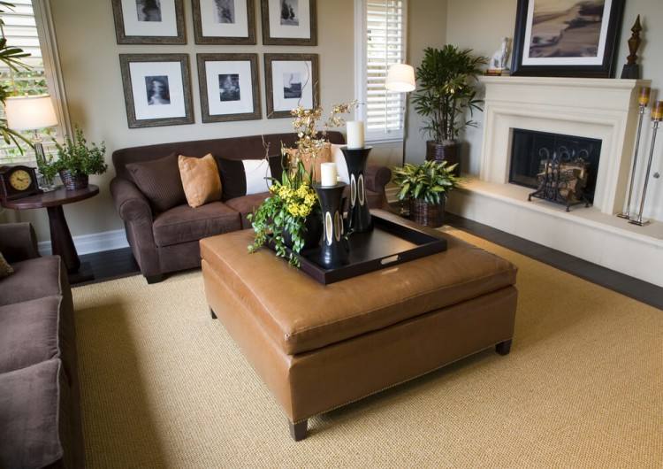 mocha fabric sofa set on the floor and brown wooden fireplace  also mocha