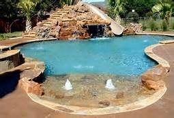 Zero beach entry swimming pool with fire pit and cascade waterfalls