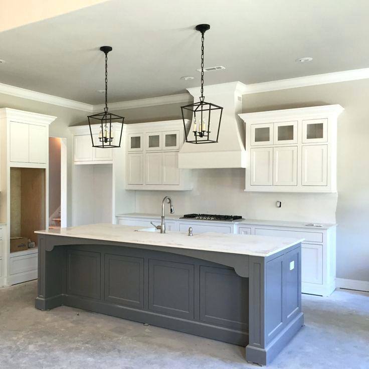 White kitchen with large kitchen island and neutral countertops