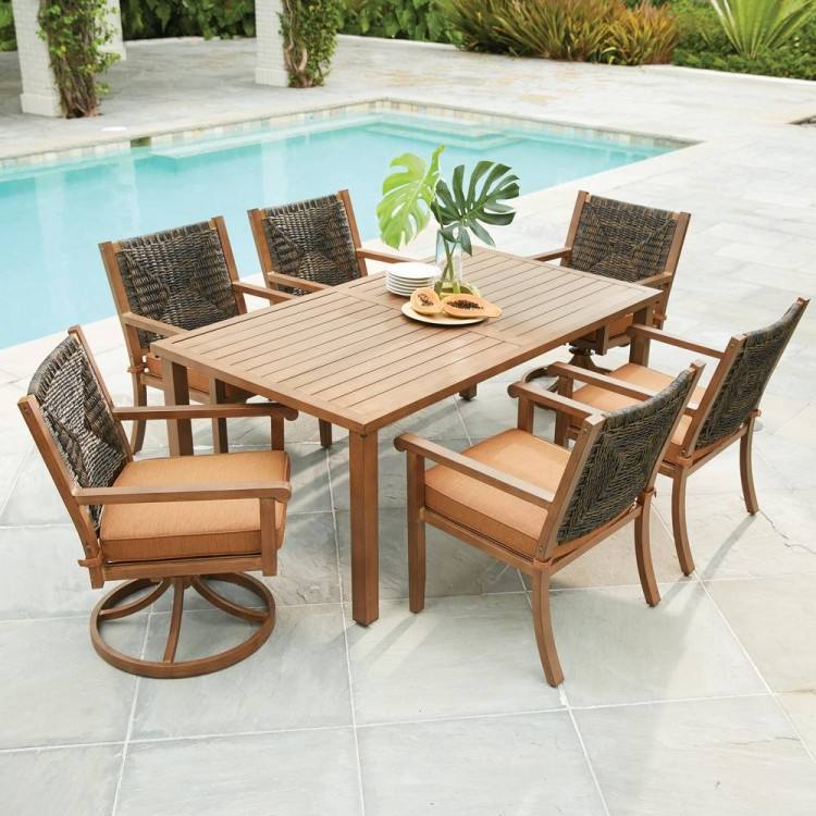 A patio conversation set with a wicker coffee table