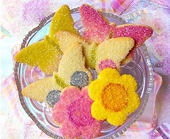 these daisy and erfly cookies were made for a tinkerbell themed baby shower