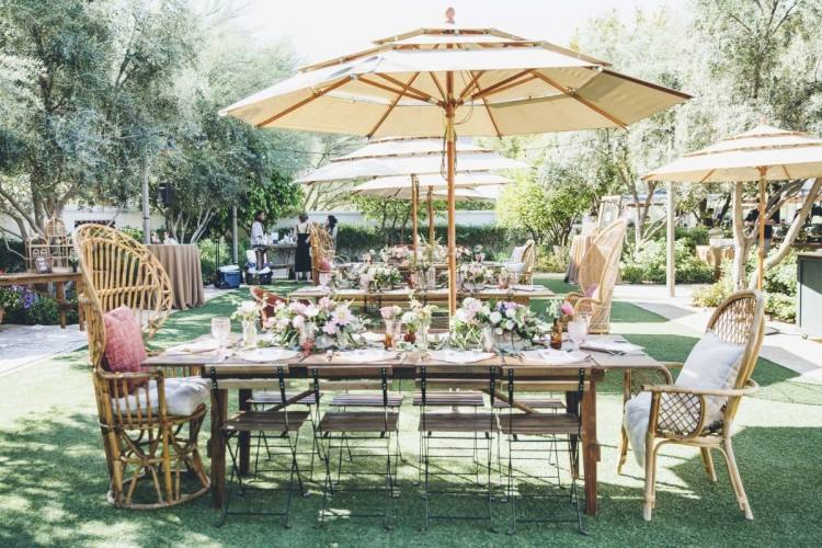 A picnic table can be simply arranged with glass jars adorned with blossoms and real retro lanterns for an outdoor party